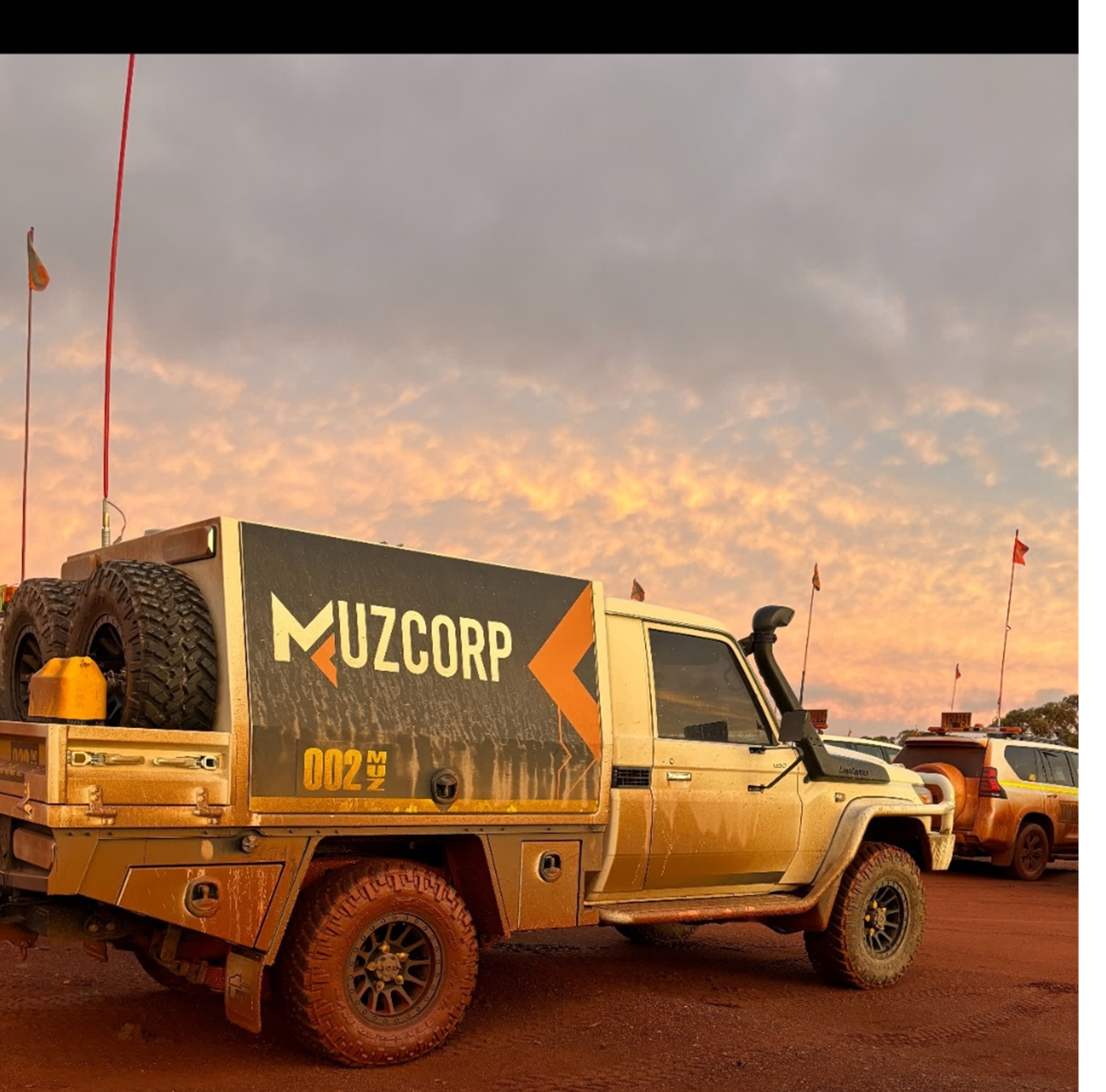 Muzcorp branded truck at sunset